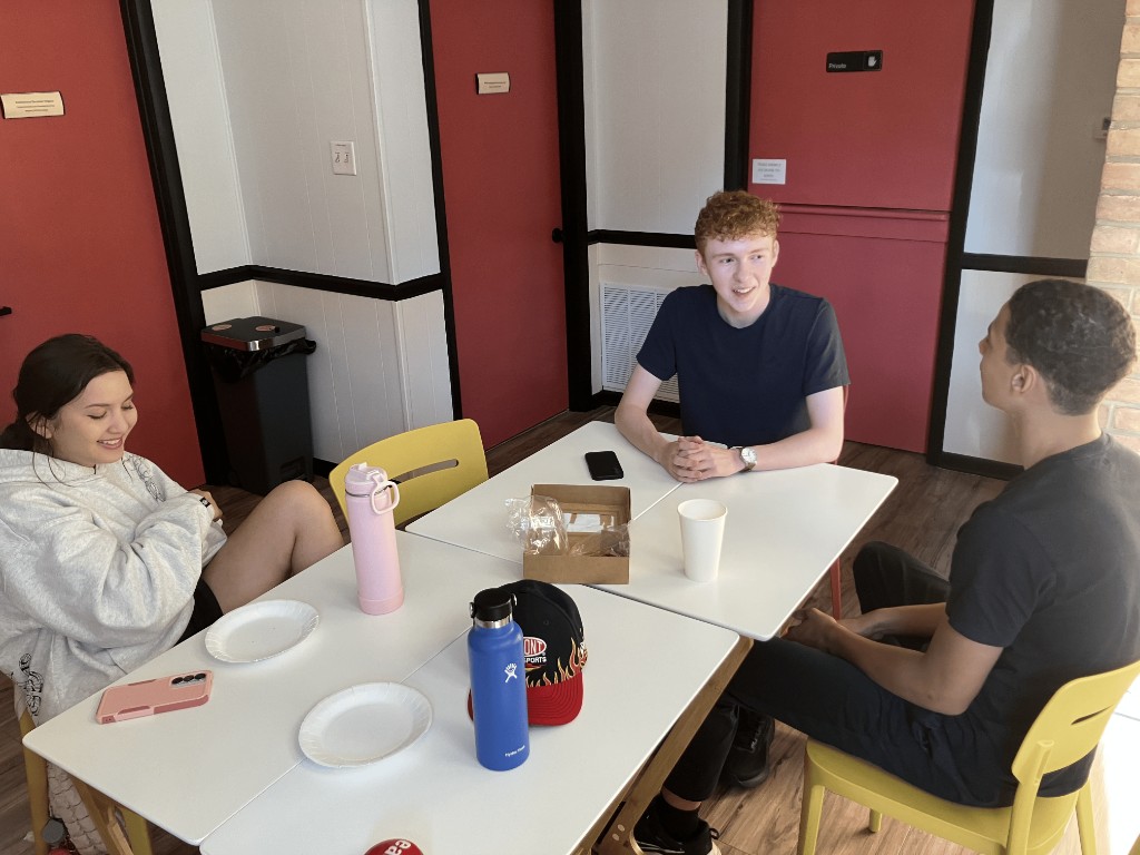 AVDC members gathered around a table at the Youth Development Center